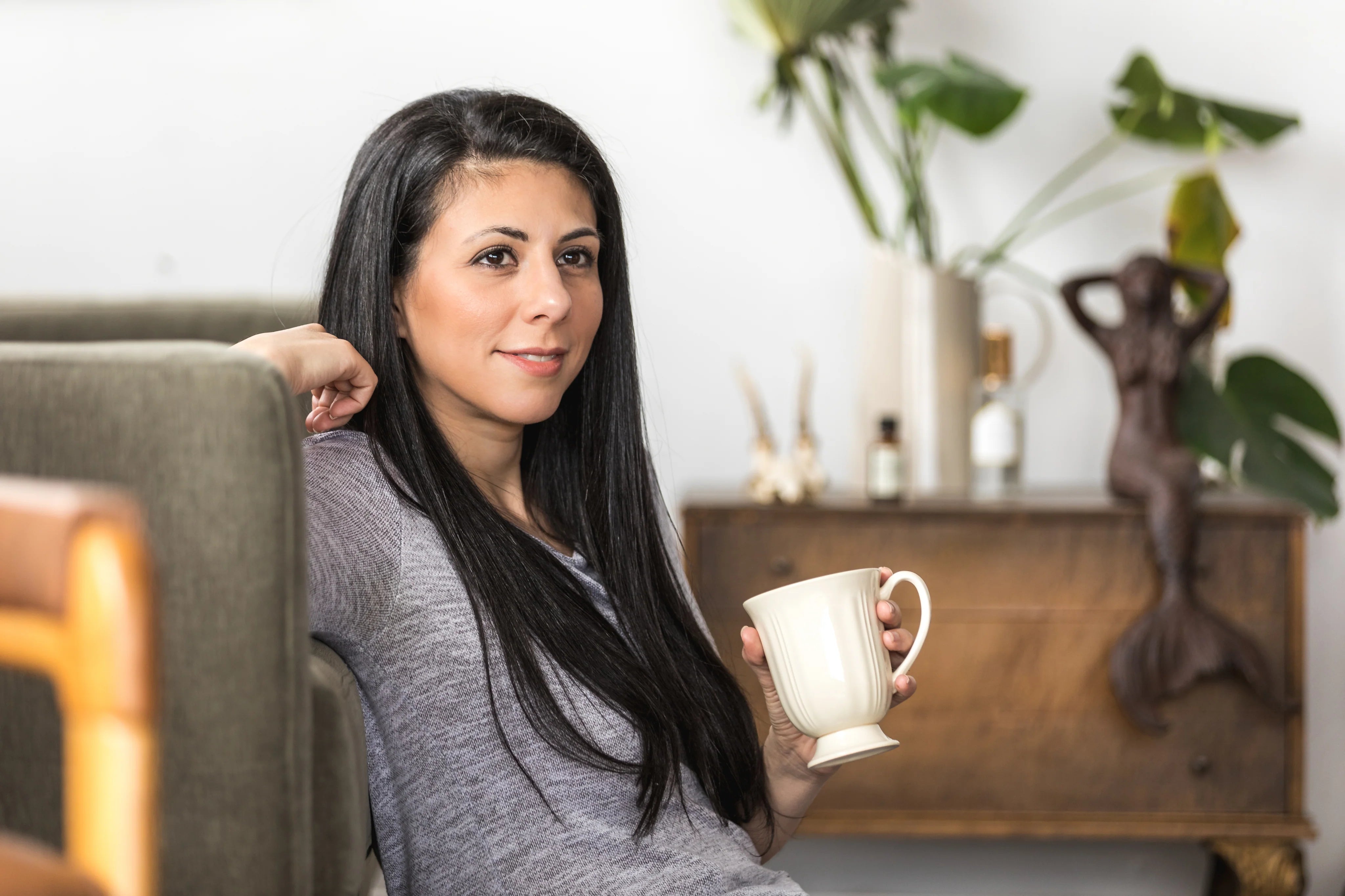 files/a-young-woman-leans-back-on-a-couch-with-a-coffee.webp